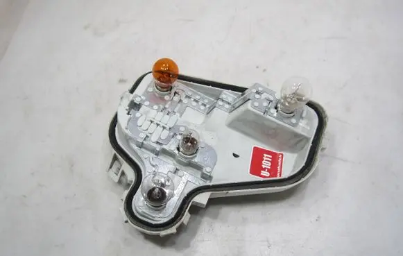 Tail light bulb cover holder