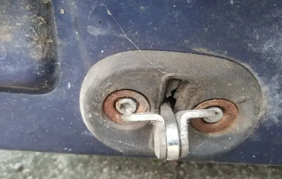 Front door check strap stopper
