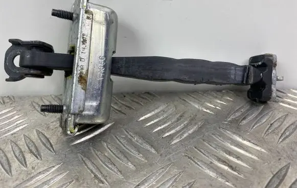 Front door check strap stopper