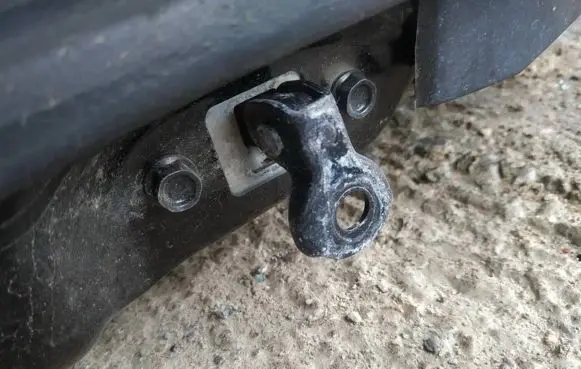 Front door check strap stopper