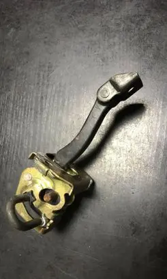 Front door check strap stopper