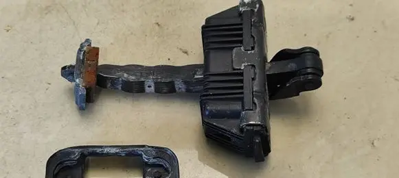 Front door check strap stopper