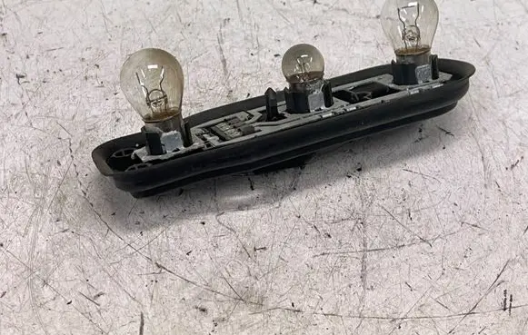 Tail light bulb cover holder