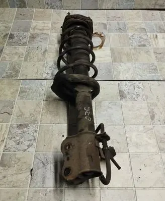 Mazda 323 F Front shock absorber with coil spring