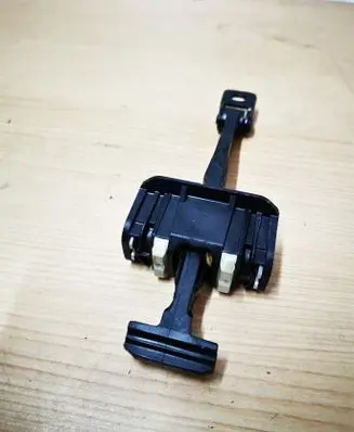 Front door check strap stopper