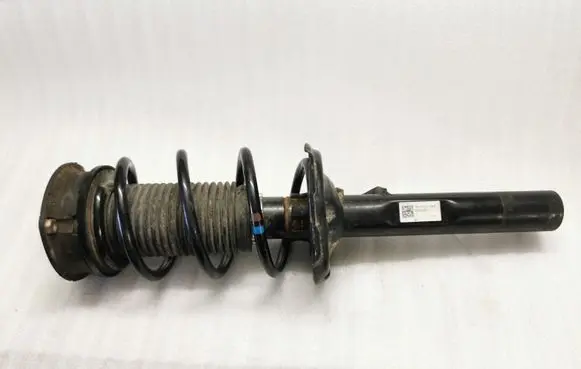 Volkswagen Golf VII Front shock absorber with coil spring 5Q0413023FJ