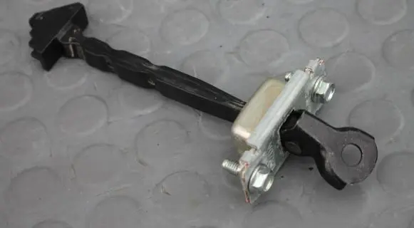 Front door check strap stopper