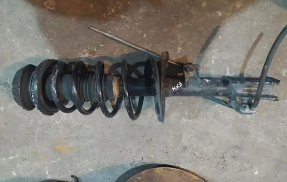 Suzuki Swift I Front shock absorber with coil spring 4160163J11