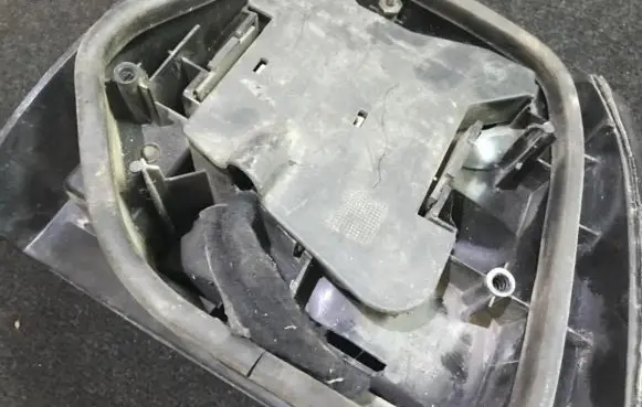 Tail light bulb cover holder