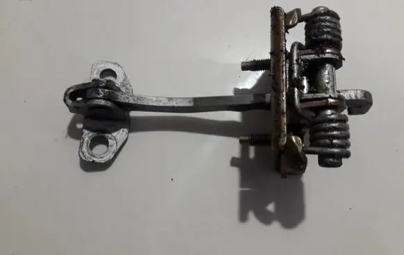 Front door check strap stopper
