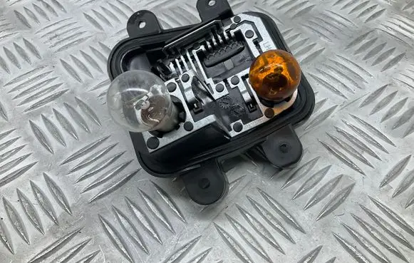 Tail light bulb cover holder