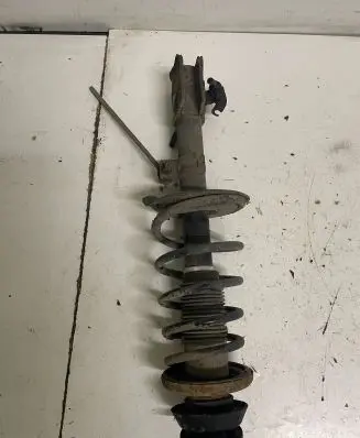 Suzuki Swift I Front shock absorber with coil spring