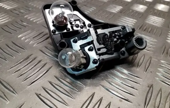 Tail light bulb cover holder