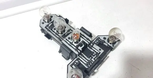 Tail light bulb cover holder