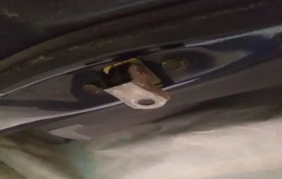Front door check strap stopper