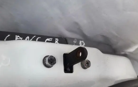 Front door check strap stopper