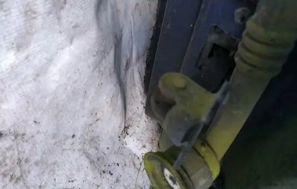 Front door check strap stopper