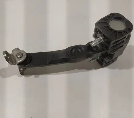 Front door check strap stopper