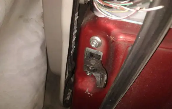 Front door check strap stopper