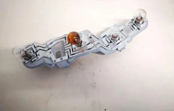 Tail light bulb cover holder