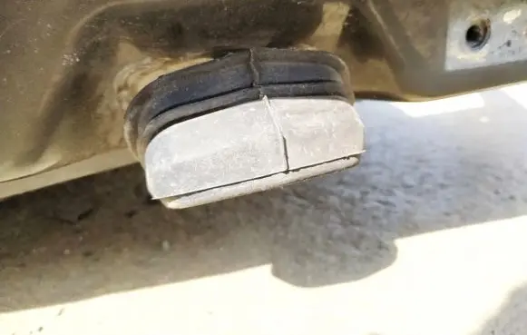 Front door check strap stopper