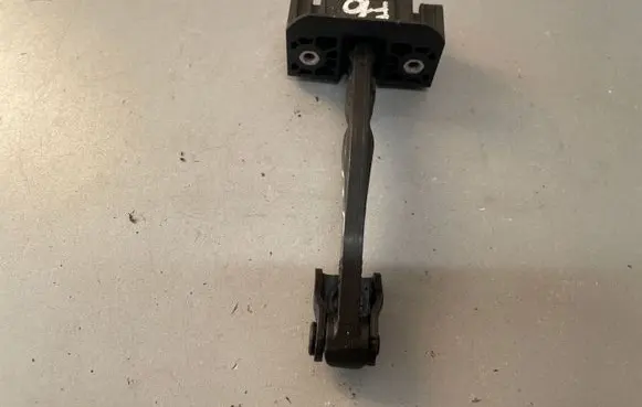 Front door check strap stopper
