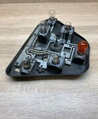 Tail light bulb cover holder
