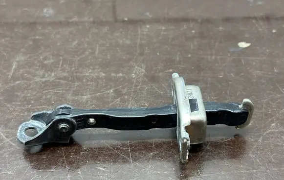 Front door check strap stopper