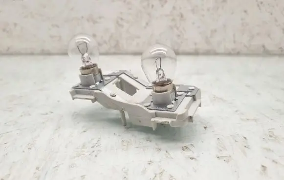 Tail light bulb cover holder