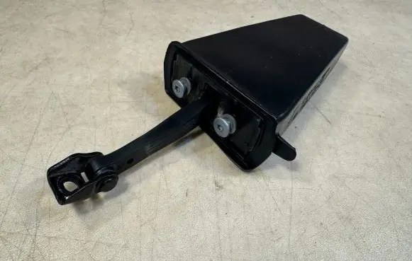 Front door check strap stopper
