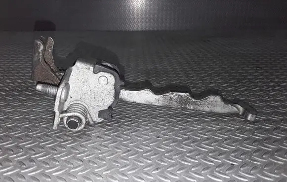 Front door check strap stopper