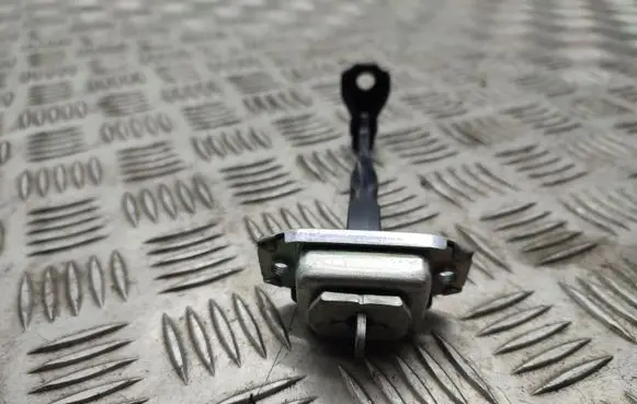 Front door check strap stopper