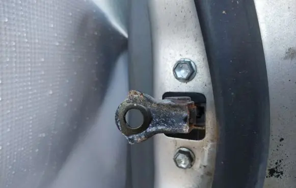 Front door check strap stopper