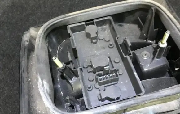 Tail light bulb cover holder