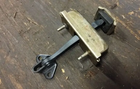 Front door check strap stopper