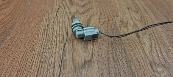 Tail light bulb cover holder