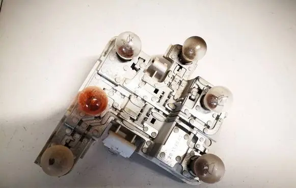 Tail light bulb cover holder