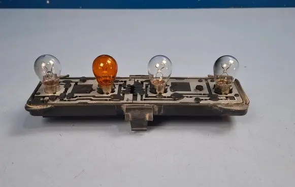 Tail light bulb cover holder
