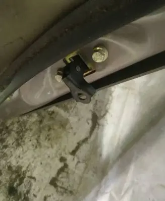 Front door check strap stopper