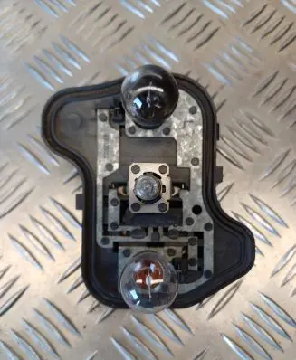 Tail light bulb cover holder