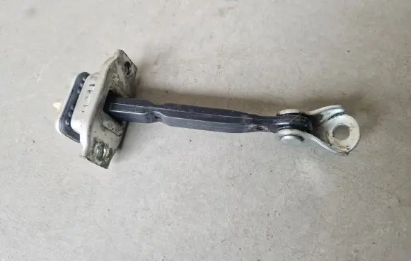 Front door check strap stopper