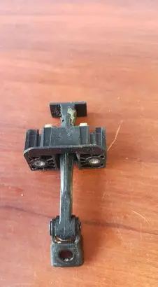 Front door check strap stopper