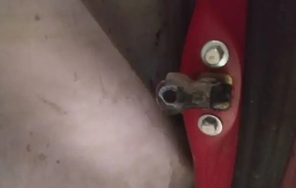 Front door check strap stopper