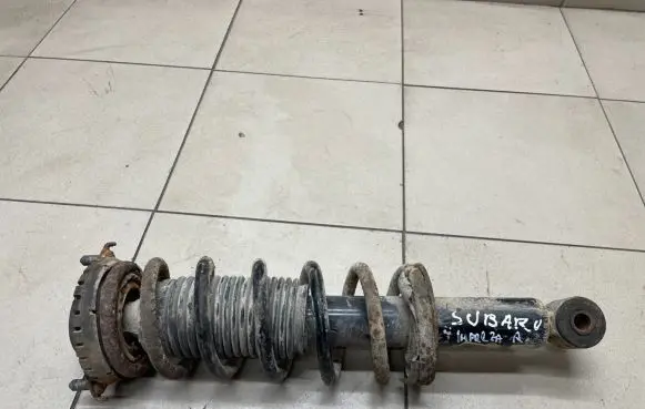 Subaru Impreza I Front shock absorber with coil spring