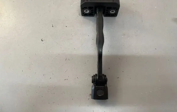 Front door check strap stopper