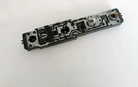 Tail light bulb cover holder