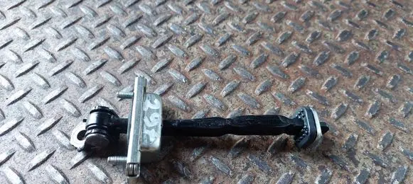 Front door check strap stopper