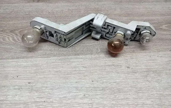Tail light bulb cover holder