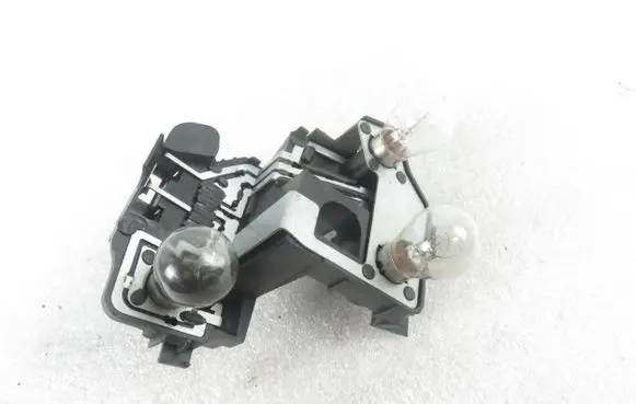 Tail light bulb cover holder