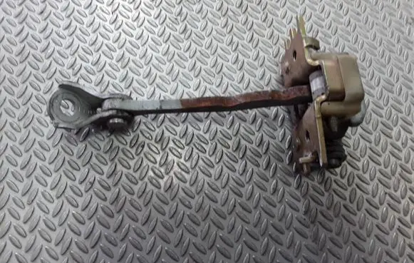 Front door check strap stopper